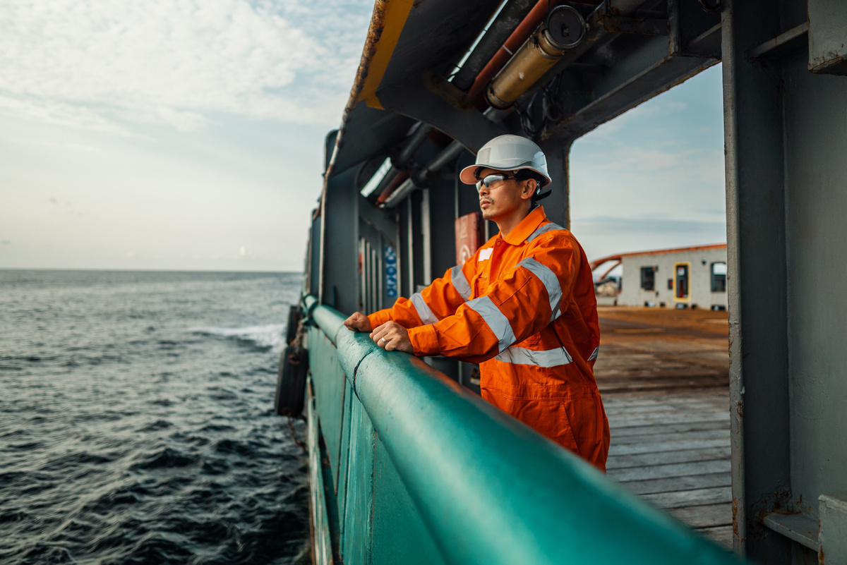 Maritime personnel wearing safety equipment on board a vessel